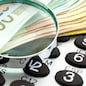 Euro Notes with calculator and magnifier. Closeup