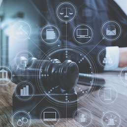 justice and law concept.Male judge in a courtroom with the gavel,working with digital tablet computer docking keyboard on wood table,eyeglass,virtual interface graphic icons diagram