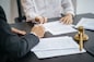 Legal counsel presents to the client a signed contract with gavel and legal law. justice and lawyer concept.