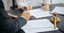 Legal counsel presents to the client a signed contract with gavel and legal law. justice and lawyer concept.