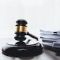 Black wooden gavel hammer and legal document in empty law firm or lawyer office background as justice and legal system for lawyer and judge, Legal authority and fairness in trials concept. equility