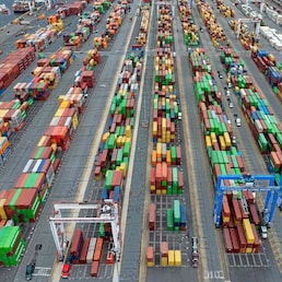(FILES) This aerial view shows shipping containers stacked at the Port of Baltimore on April 10, 2025, in Baltimore, Maryland. US President Donald Trump ordered the reimposition of tariffs on dozens of trading partners on July 31, 2025 -- his cornerstone strategy for reshaping global trade to benefit the US economy. However in a minor reprieve, the White House said the measures will take effect in a week, not on August 1 as previously expected. (Photo by Jim WATSON / AFP)