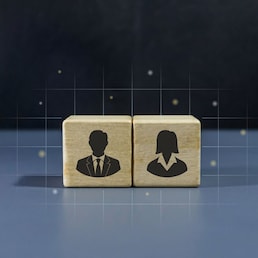 Two wooden blocks with man and woman icon on dark background. Concept of gender equality.