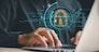 Prioritize data protection and privacy in the digital age. Businessmen safeguard personal information on laptops and virtual interfaces with shield lock icons and advanced network security technology.