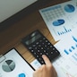 Businessmen are pointing numbers, graph, chart in business results. Business concept.
