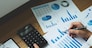 Businessmen are pointing numbers, graph, chart in business results. Business concept.