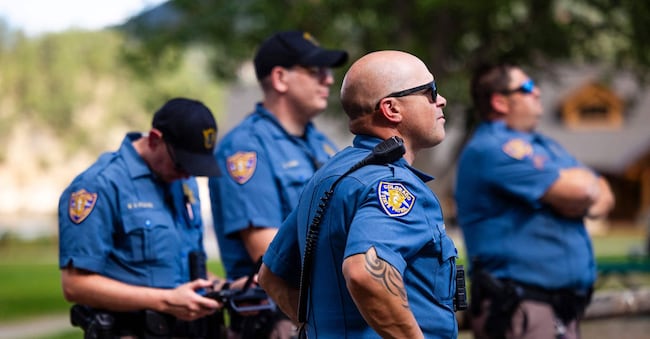 EVERGREEN, COLORADO - SEPTEMBER 10: Colorado State Patrol officers watch as they fly a drone over the site of a shooting at Evergreen High School on September 10, 2025 in Evergreen, Colorado. At least three students, including the suspected shooter, were injured in the attack.   Michael Ciaglo/Getty Images/AFP (Photo by Michael Ciaglo / GETTY IMAGES NORTH AMERICA / Getty Images via AFP)
