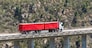 Bloukrans Bridge, Eastern Cape, South Africa. Dec 2019. Bloukraans Bridge carrying a toll road 216 metres above the gorge  Passing over a red truck and trailer.