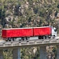 Bloukrans Bridge, Eastern Cape, South Africa. Dec 2019. Bloukraans Bridge carrying a toll road 216 metres above the gorge  Passing over a red truck and trailer.