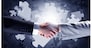 Close up of business handshake with puzzle elements at background
