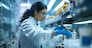 A pharmacist carefully preparing prescription medication in a state-of-the-art compounding lab with sterile equipment