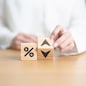 wood block of percentage change to UP and Down arrow. Interest rate, GDP, stocks market, financial, deflation and Inflation, ranking, mortgage, debt, Loan and Economic Recession concept