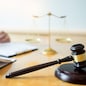 Male lawyer working with contract papers and reading law book in a courtroom, justice and law concept while presiding over trial