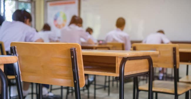 Lecture room or School empty classroom with Student taking exams, writing examination for studying lessons in high school thailand, interior of secondary education, whiteboard. educational concept