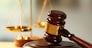Wooden judges gavel on wooden table, close up
