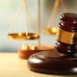 Wooden judges gavel on wooden table, close up