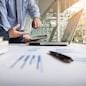 Business adviser analyzing financial figures denoting the progress in the work of the company.