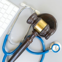 law gavel, stethoscope and face anti virus masks, medical law concept, copy space