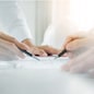 Architects engineer discussing at the table with blueprint - Closeup on hands and project print, Team group on construciton site check documents and business workflow