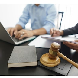 Lawyer and legal concept, Businessman typing on laptop as senior lawyer explain detail of contract.