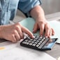 Female accountant using calculator in office