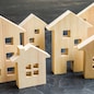 City of wooden figurines of houses. Buying and selling real estate. Renovation and home improvement. Mortgage loan. Building maintenance. Renting housing, realtor services.