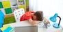 education, cyberbullying and people concept - tired or sad student boy with laptop computer lying on desk at home suffering from bullying