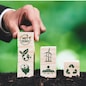 Businessman putting Net Zero symbol cube on stack top for corporate environmental protection and sustainability. Modern house model power by clean wind energy with net zero CO2 emission concept. Alter