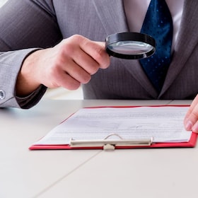 Man looking for errors and mistakes in report