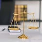 Lawyer woman holding document and working about business contract with brass balance scales on desk.