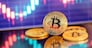 Gold Bitcoin crypto currency on background of chart diagram.