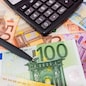 different euro banknotes, calculator, magnifier and pen. Financial concept.