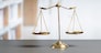 Shiny golden balanced scale in court library background as concept justice and fairness legal symbol. Scale balance for righteous and equality judgment by lawyer and attorney. equility