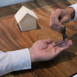 Real estate agent giving keys to customer after contract signature