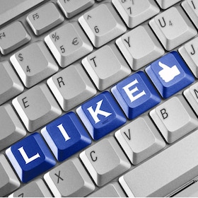 Social network concept . Keyboard with blue Like button.