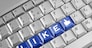 Social network concept . Keyboard with blue Like button.