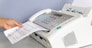 hand man are using a fax machine in the office Business concept