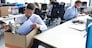 Sad dismissed worker are taking his office supplies with him from office.
