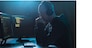 cybercrime, hacking and technology concept - male hacker with headphones and coding on laptop computer screen wiretapping or using computer virus program for cyber attack in dark room