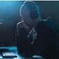 cybercrime, hacking and technology concept - male hacker with headphones and coding on laptop computer screen wiretapping or using computer virus program for cyber attack in dark room