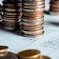 Pile of gold coins stack in finance treasury deposit bank account for saving . Concept of corporate business economy and financial growth by investment in valuable asset to gain cash revenue profit .