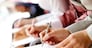 Businesspeople hands over papers making notes at seminar