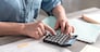 Female accountant using calculator in office
