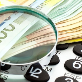 Euro Notes with calculator and magnifier. Closeup