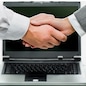 Woman and man shaking hands on the background of opened laptop