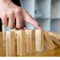 Business finger stops domino continuous overturned meaning that hindered business failure. Stop over this business failure concept.