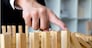 Business finger stops domino continuous overturned meaning that hindered business failure. Stop over this business failure concept.