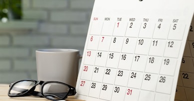 Calendar page close up on wooden office desk