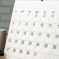 Calendar page close up on wooden office desk
