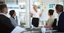 Presentation, woman and whiteboard with staff in office for workflow steps, diagram and teamwork for web design. Female speaker, people and meeting of strategy process, chart and interface project.